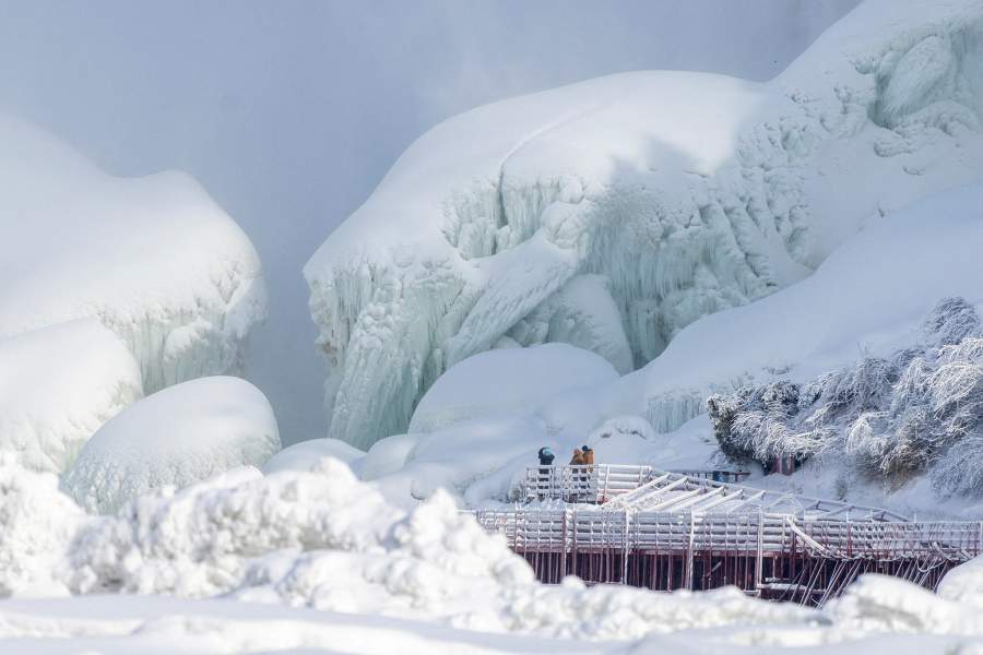 A partially frozen boardwalk tourist attraction near the American Falls is seen from Niagara Falls, Ontario, Canada, January 31