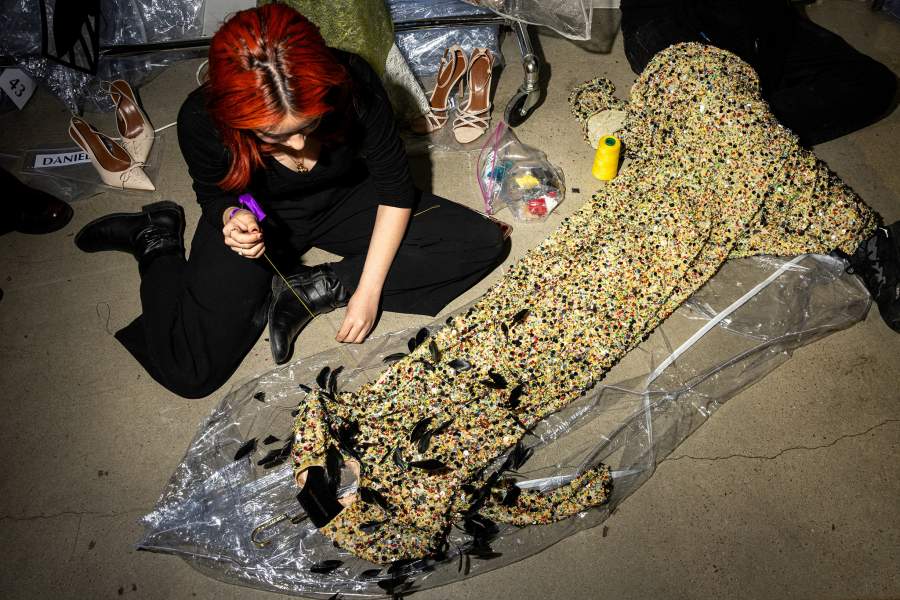 Dress makers put finishing touches on creations for Christian Siriano's Fall/Winter 2026 collection show during New York Fashion Week in New York City, U.S., February 12, 2026. REUTERS/Angelina Katsanis