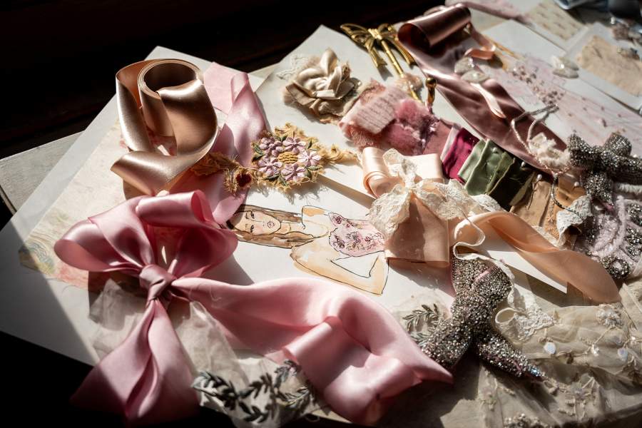 Decorations and sketches are displayed on a table at the LoveShackFancy Fall 2026 collection presentation during New York Fashion Week in New York City, U.S., February 11, 2026. REUTERS/Angelina Katsanis