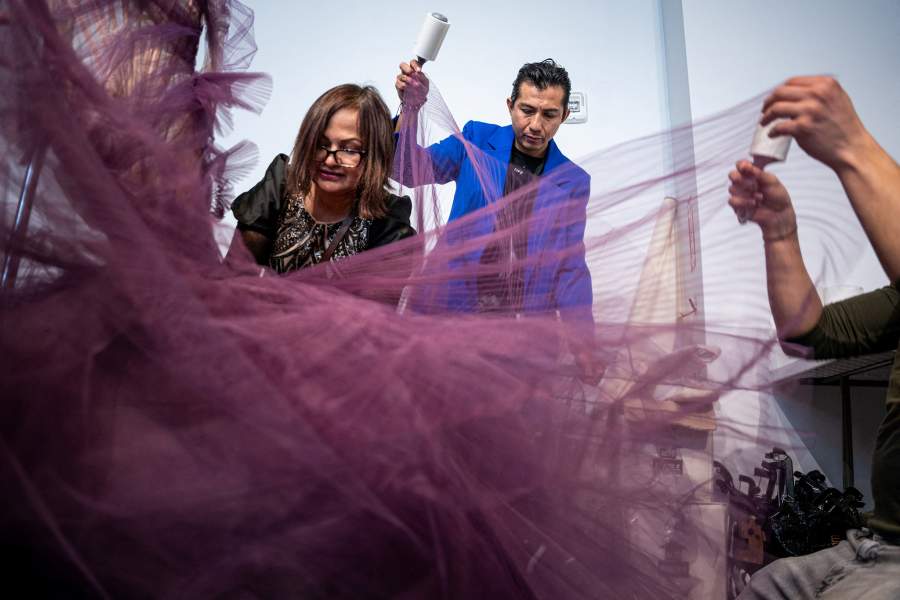Dressers put finishing touches on creations for Christian Siriano's Fall/Winter 2026 collection show during New York Fashion Week in New York City, U.S., February 12, 2026. REUTERS/Angelina Katsanis