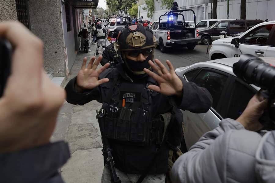 On February 22, 2026, in Mexico City, Mexico, members of the National Guard carry out a major operation after federal forces kill Nemesio Oseguera Cervantes 'El Mencho', leader of the Jalisco New Generation Cartel. The operation takes place outside the Specialized Prosecutor's Office for Organized Crime of the Attorney General's Office, where the convoy escorts a forensic ambulance