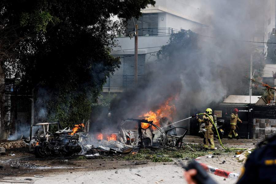 A firefighter works to put out a fire at an impact site, following missile barrages launched at Israel from Iran, amid the U.S.-Israel conflict with Iran, in central Israel March 15, 2026.