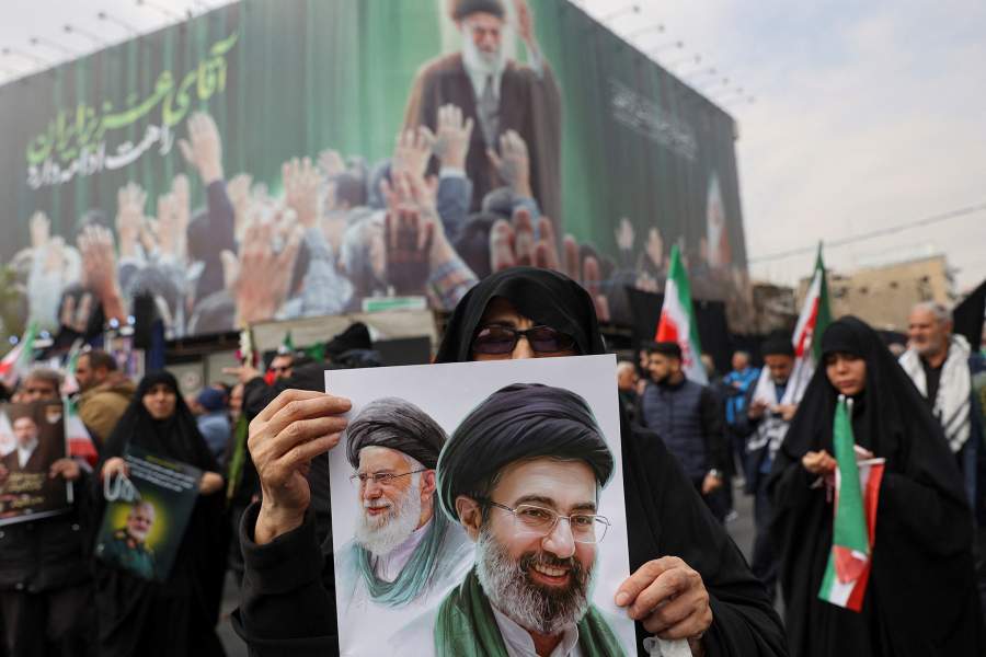 A woman holds an image of Iran's new supreme leader, Mojtaba Khamenei, alongside late Iranian Supreme Leader Ayatollah Ali Khamenei, during a funeral ceremony for the Iranian military commanders who were killed in strikes, amid the U.S.-Israeli conflict with Iran, in Tehran, Iran, March 11, 2026. Majid Asgaripour/WANA (West Asia News Agency) via REUTERS ATTENTION EDITORS - THIS PICTURE WAS PROVIDED BY A THIRD PARTY