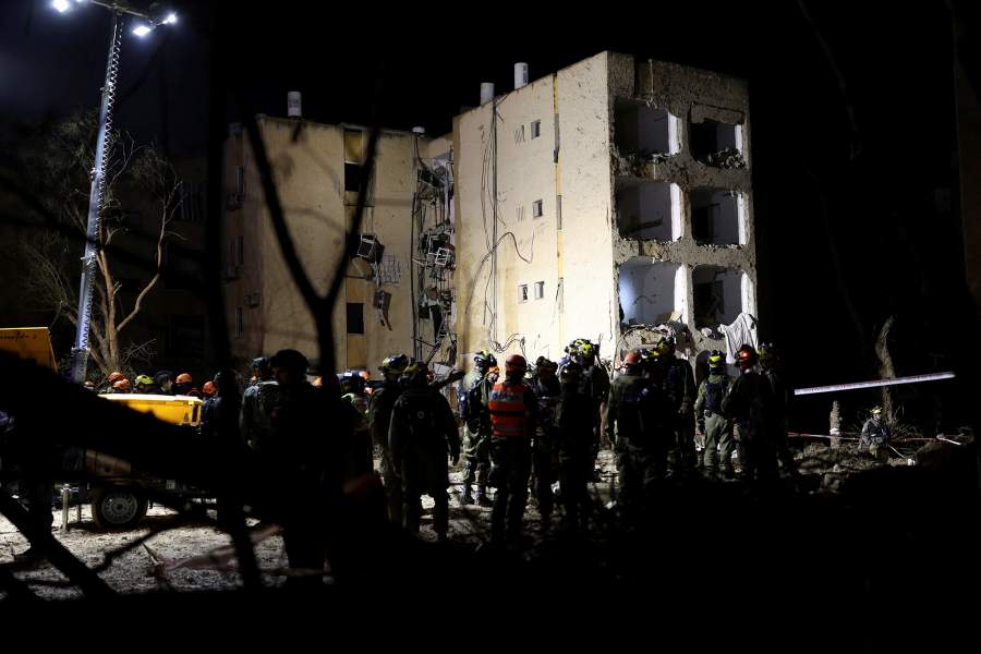 Israeli soldiers work at the scene of damage after Iranian missile barrages struck residential buildings in Arad, amid the U.S.-Israel conflict with Iran, in southern Israel, March 22, 2026