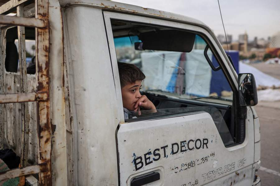 A child sits inside a vehicle as displaced people pack up their belongings and prepare to return to their homes after a 10-day ceasefire between Lebanon and Israel went into effect, in Beirut, Lebanon, April 17, 2026