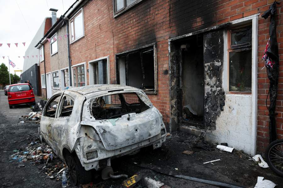 Debris lies scattered next to a damaged car and building, in the aftermath of anti-immigrant protests following a knife attack on June 8, which left a man seriously injured and prompted police to declare a critical incident, at Lendrick Street, east Belfast, Northern Ireland, June 10, 2026. REUTERS/Isabel Infantes