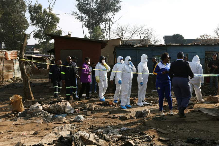 Members of the forensics team arrive at the scene after, according to the police, gunmen opened fire at an informal settlement in Cleveland, Johannesburg, South Africa, June 10, 2026. REUTERS/Siphiwe Sibeko