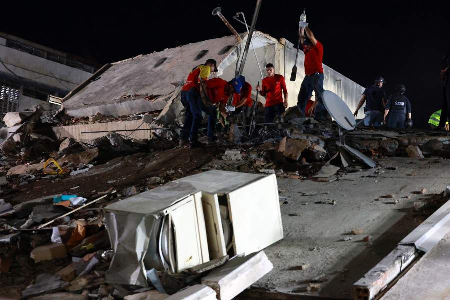 Rescue workers search through the rubble of a collapsed building after an earthquake in Caracas, Venezuela, Wednesday, June 24, 2026