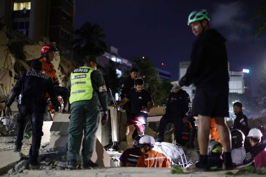 Firefighters and responders search for victims in a demolished building at San Bernardino after a magnitude 7.2 earthquake struck Venezuela and other regions in the Caribbean on June 24, 2026