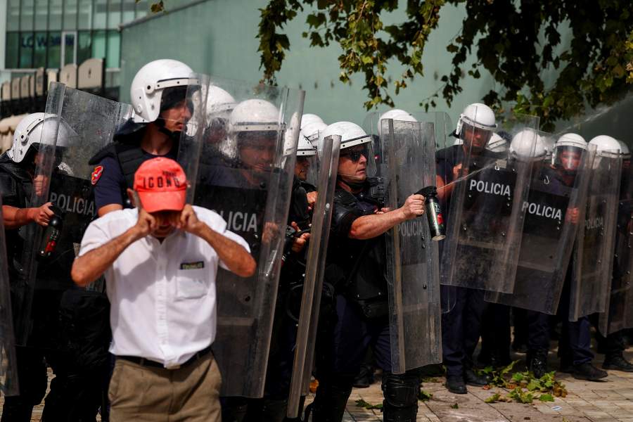 A man reacts, as police officers equipped with riot shields deploy pepper spray, during a demonstration against the government, following weeks of protests against a planned luxury resort backed by a company linked to Jared Kushner, the son-in-law of U.S. President Donald Trump, on an environmentally sensitive part of the Adriatic coast, in Tirana, Albania, July 2, 2026