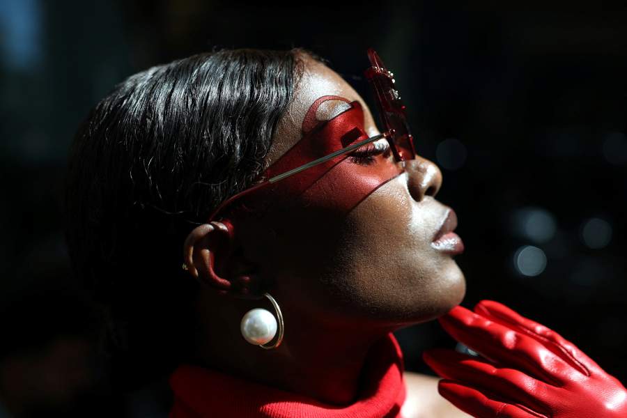 A woman poses as she walks nearby the Dolce & Gabbana spring/summer 2027 show location during Fashion Week in Milan, Italy, September 26, 2026. 