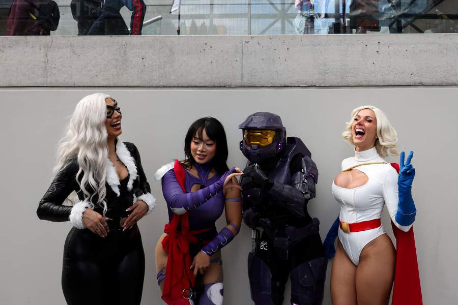 People cosplaying as Marvel's Black Cat and Psylocke, a Spartan from the Halo franchise, and DC's Power Girl pose during the opening day of New York Comic Con at the Jacob Javits Center in Manhattan in New York City, U.S., October 8, 2026
