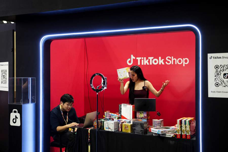 A person films products at a popup TikTok Shop during the opening day of New York Comic Con at the Jacob Javits Center in Manhattan in New York City, US, October 8, 2026.