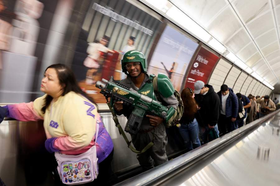 A man wearing a costume takes an escalator out of the subway as he heads to the opening day of New York Comic Con in Manhattan in New York City, U.S., October 8, 2026.