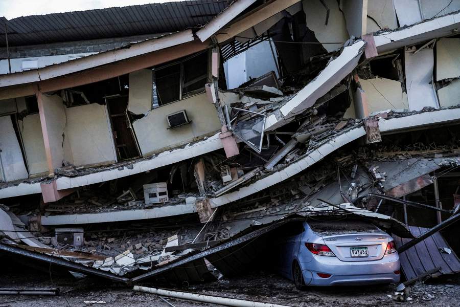 A car sits crushed beneath debris from a collapsed building after an earthquake struck near the southern coast of Panama, in Penonome, Panama, October 10, 2026. 